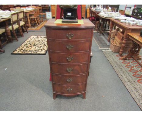 A mid 20th Century mahogany reproduction slender bow front chest of six small drawers on swept bracket feet. 107cm x 49cm x 4