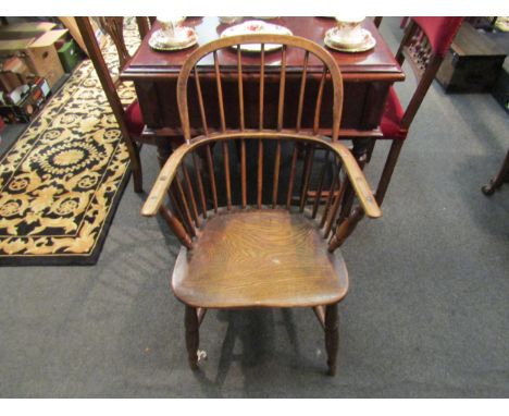 A 19th Century low stick-back Windsor chair with elm saddle seat and "H" stretcher, repaired 