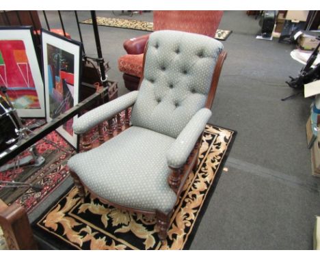 A late Victorian/early Edwardian oak slipper chair with turned spindle supports and brass castors, button-back blue upholster