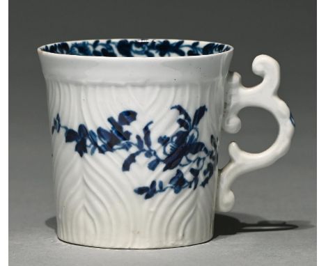 A Worcester blue and white coffee can, c1755-1757,&nbsp; with ornate C scroll handle, painted with the Feather Mould Floral p