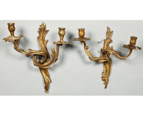 A French ormolu wall light, mid 20th c, in Louis XV style, 37cm h and another, giltmetal (2) Both complete, somewhat dusty / 