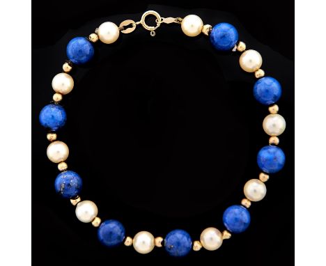 A lapis lazuli and cultured pearl bracelet, with gold spacers and clasp marked 14k Good condition