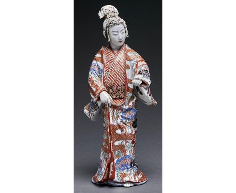 A Japanese Imari figure of a bijin, Meiji period, her kimono decorated with wisteria, bamboo and textile patterns, 46cm h Bla