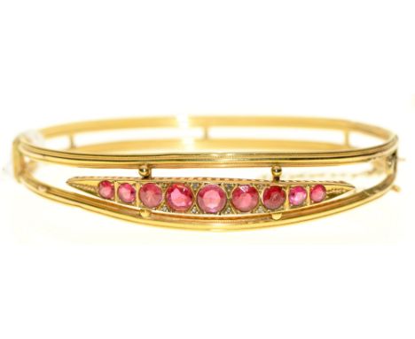 A synthetic ruby bangle, in gold, 63mm, unmarked, 6.1g Slight distortion on lower half