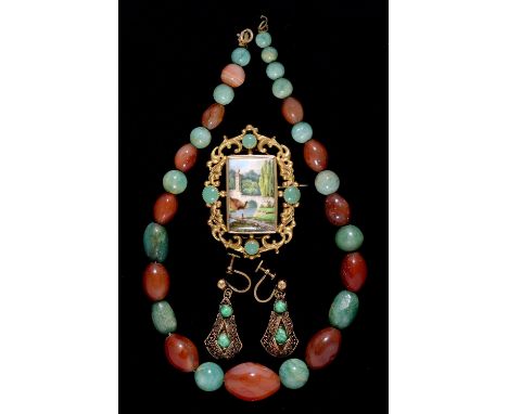 A necklace of jade and cornelian beads, 36cm l, a giltmetal brooch set with a porcelain plaque painted with a river scene and