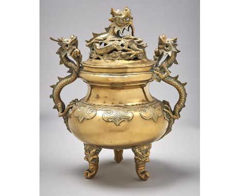 A Chinese brass tripod vessel and cover, late 19th / early 20th c, with dragon handles, 34cm h Good condition, old polish res