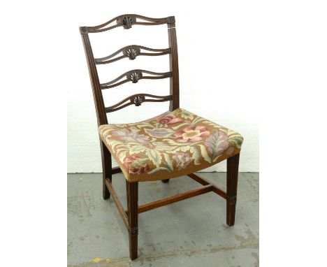 A George III mahogany dining chair, c1780, with anthemion carved and pierced ladder back and dished seat, on fluted forelegs,