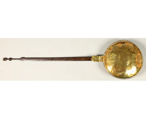 A Dutch brass warming pan, 18th c, the lid decorated with stylised flowers, iron handle, 113cm l Lid associated and with seve