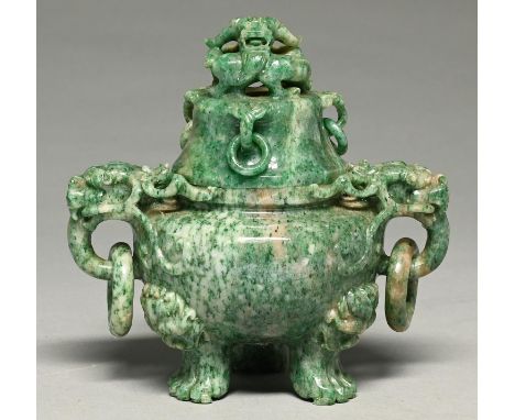 A Chinese mottled green stone tripod vessel and cover, 20th c, with loose rings, 15.5cm h Good condition