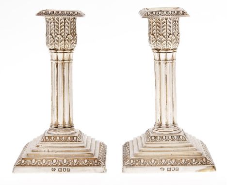 A pair of Edward VII silver dwarf cluster columnar candlesticks, on stepped square foot, nozzles, 14cm h, by W Hutton &amp; S