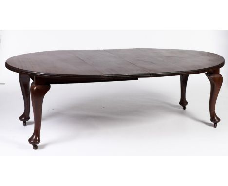 A mahogany extending dining table in Queen Anne style, the oval top with two additional leaves, cabriole legs with pad feet f
