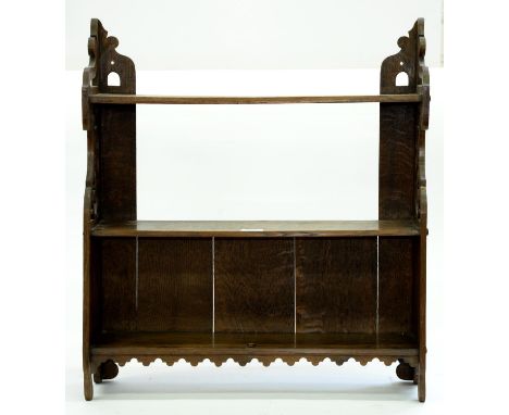 A set of oak hanging shelves, first half 20th c, with shaped fretwork sides, 64cm h; 15 x 58cm Good condition