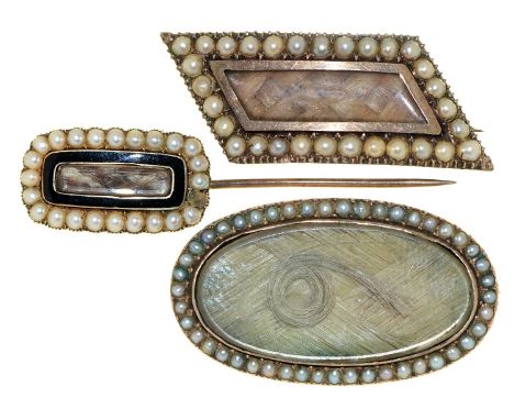 Three English mourning brooches, early 19th c, of gold or gold and enamel with split pearl surround and inset hair, reverse o