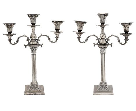 A pair of Edwardian EPNS&nbsp; three light candelabra,&nbsp; with beaded drip pans and scrolling branches, on corinthian colu
