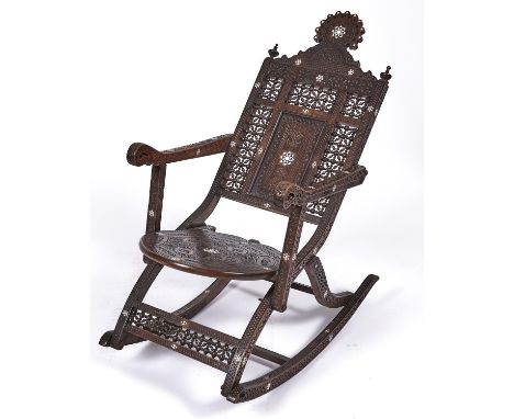 A Syrian ivory and mother of pearl inlaid and carved wood rocking chair, late 19th c, with round seat and spindle panels, 92c