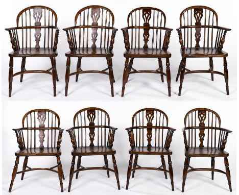 A set of eight reproduction yew wood low back Windsor elbow chairs, late 20th c, pierced splats, dished seats on turned legs 
