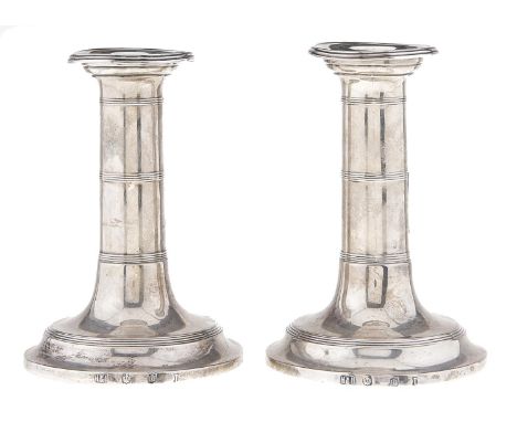 A pair of Scottish Edward VII silver dwarf candlesticks, with reeded bands, nozzles, 12cm h, by Hamilton &amp; Inches, 1909, 