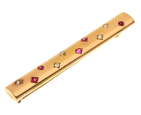 An art deco ruby and diamond bar brooch in the form of a gold baton, c1930, 60mm l, unmarked, 7g Slight wear consistent with 