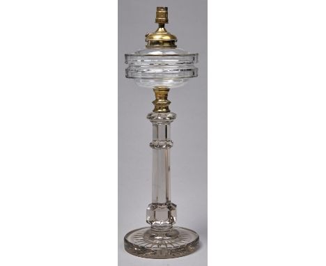 An Edwardian columnar cut glass oil lamp and detachable fount, with brass fitment, on stepped star cut foot, 48cm h excluding