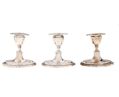 One and a pair of Edwardian silver dwarf navette shaped candlesticks, nozzles, 90mm h, by Thomas A Scott, Sheffield 1905 and 