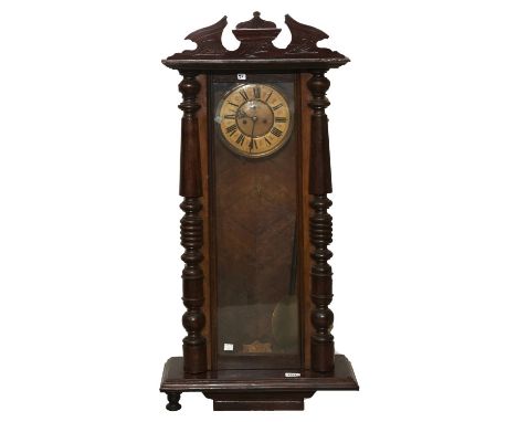 A walnut and stained wood Vienna wall clock, c1900, pendulum and two brass sleeved weights, 103cm h Dial discoloured, veneers