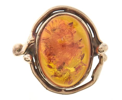 An amber ring, in gold, apparently unmarked, 5.9g, size H Slight wear scratches