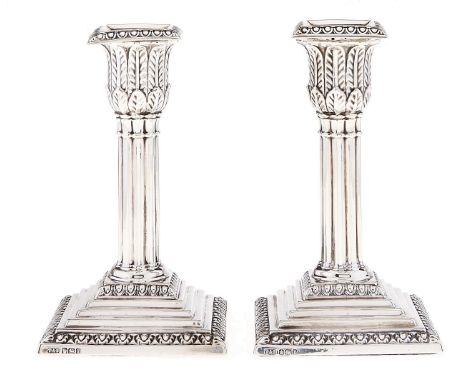 A pair of Edward VII silver dwarf cluster columnar candlesticks, on stepped square foot, nozzles, 14cm h, by Thomas A Scott, 