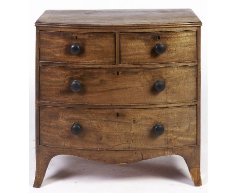 A Regency mahogany bow front chest of drawers, the top applied moulded lip, fitted two short and two long cockbeaded drawers 