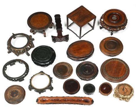 Fifteen Chinese and Japanese wood stands, two others, one of turned mahogany with brass gallery and two late 19th c patinated