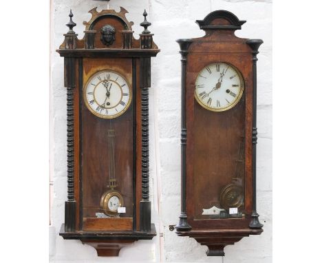 Two walnut and ebonised Vienna wall timepieces, c1900, with enamel dial, gridiron pendulums, 75cm h and circa Cases affected 