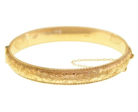 A 9ct gold bangle, 63mm, Birmingham 1968, 13.5g Shallow dent in one place but no signs of wear