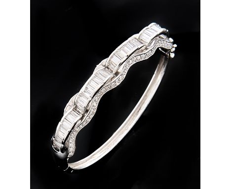 A gem set white gold bangle, foreign control mark, 24.9g Good condition with a few light scratches only