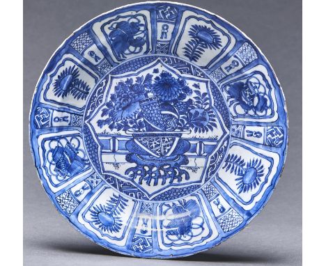 A Chinese Kraak porcelain dish, c1615-30, painted to the centre with a hanging basket with protruding roots&nbsp; and filled 