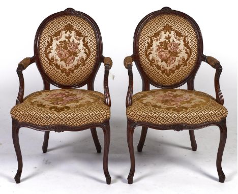 A pair of mahogany open armchairs, in so-called French "Hepplewhite" style, carved with pendant husks, padded back and stuffe