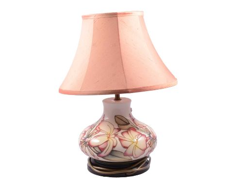 Moorcroft pottery table lamp, compressed vase form with magnolia design, with shade, height overall 41cm.