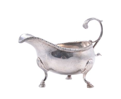 A George II silver sauce boat, Walter Brind, London 1758, gadrooned rim, flying scroll handle, on three raised hoof feet, eng