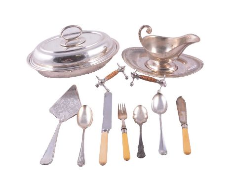 A  silver-plated lidded entree dish; silver-plated gravy boat with saucer; tablespoons; knives; forks; knife rests; cake slic