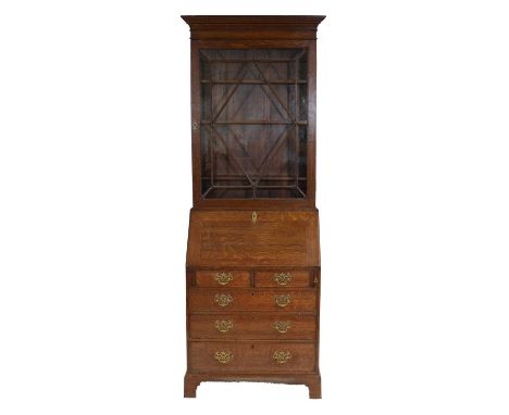 George III style oak bureau bookcase, cavetto cornice, glazed door enclosing three adjustable shelves, fall front encloisng a