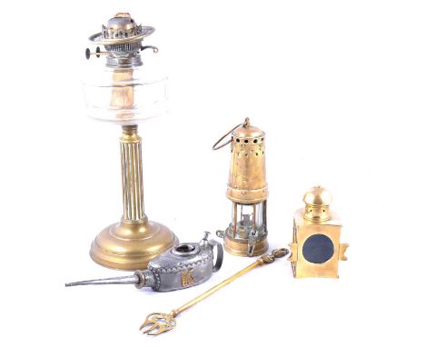 Old brass miner's lamp; brass railway lamp; Victorian oil lamp; a brass-frame table lamp; and other items of small metalware;