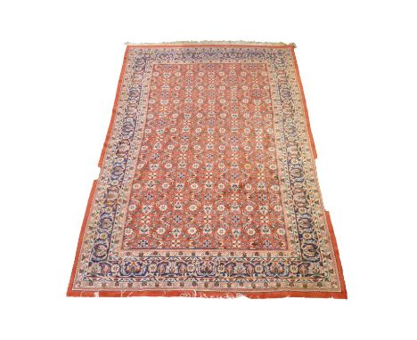 Small Agra carpet, flower filled field on a red ground, border within guards, 310 x 185cm.