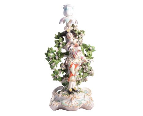 Chelsea candlestick figure, young man with a peacock, 32cm, restored.