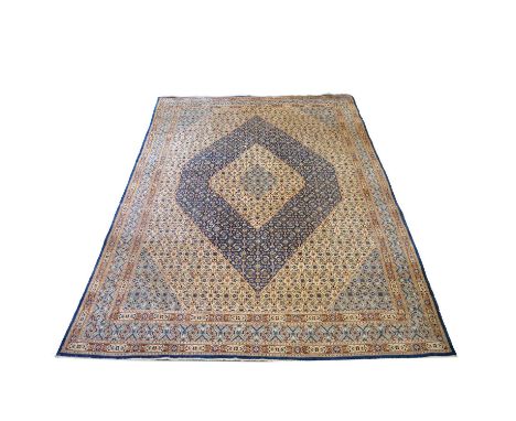 Iranian Hamadan carpet, concentric blue lozenges to the cream field, enclosed by blue borders, 390x266cm.  Condition report:T