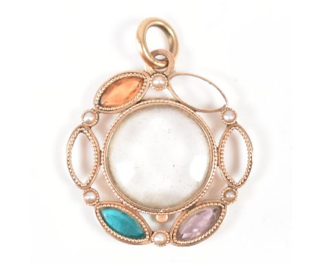 A 19th Century Victorian gold locket. The locket having a central clear panel surrounded by marquise cut coloured stones (som