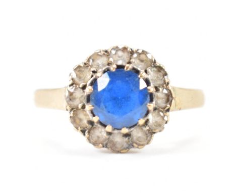 A hallmarked 9ct gold blue and white stone ring. The ring being set with a round cut blue stone with a halo of white stones. 