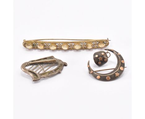 A group of antique brooches. The lot to include a gold plated filigree bar brooch set with seven oval cut citrines, a Victori