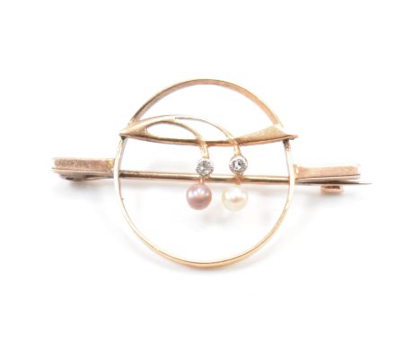 A 1930s gold diamond and pearl brooch pin. The brooch in an open work design having two diamond and pearl drops in a floral m