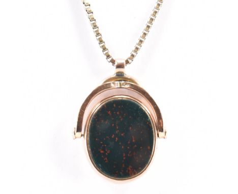 A Victorian 19th century gold swivel fob pendant. The pendant having bloodstone panel to one side and carnelian panel to vers