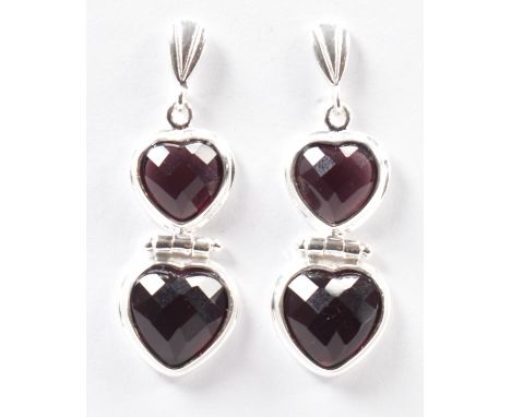A pair of 925 silver &amp; amethyst heart drop earrings. The stud earrings set with two faceted heart cut bezel set&nbsp;amet