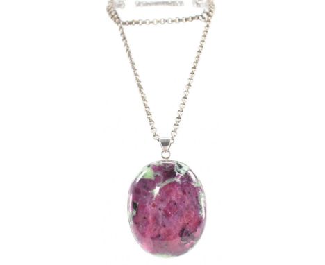 A vintage silver and zoisite pendant on a white metal necklace chain. The pendant having an oval pink and green zoisite and s