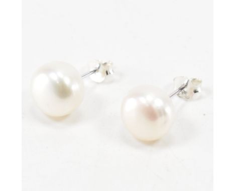 A pair of 925 silver &amp; cultured pearl stud earrings. The studs having rounded white cultured pearls set to post backs wit